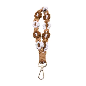 Hand-woven bohemian daisy macrame wristlet lanyard in brown and white finish
