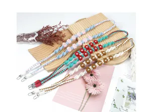 Detail view of colorful bohemian hand-woven flower phone lanyards with metal clips