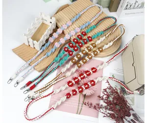 Detailed macro view of bohemian woven phone straps featuring various colorful flower patterns
