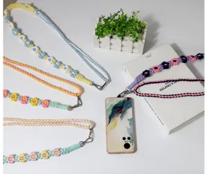 Detail view of colorful bohemian braided daisy flower lanyards and phone straps with hooks