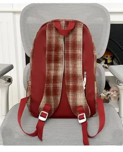 Retro plaid and red backpack back view showing adjustable straps and zipper pocket details.