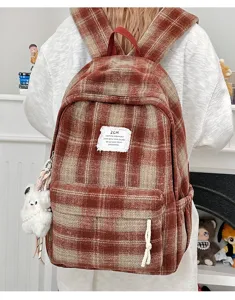Vintage plaid backpack detail, cozy fabric texture, front pocket design, casual daily wear.