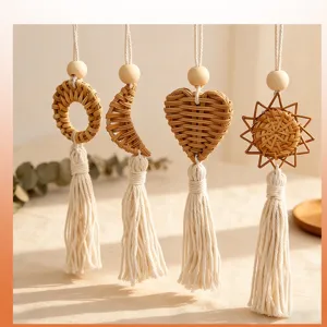 Close-up of bohemian handmade woven rattan wall hangings with cream cotton rope tassels