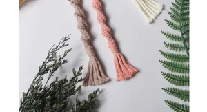 Handmade woven macrame phone charm detail, stylish braided keychain and bag accessory pendant.