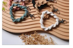 Detailed macro shot of various handmade braided phone wrist straps with metal clasps