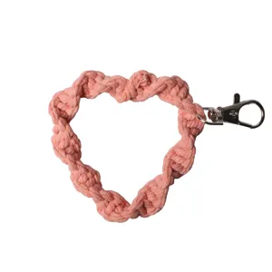 Handmade pink macrame heart-shaped phone wrist strap featuring a durable metal clasp
