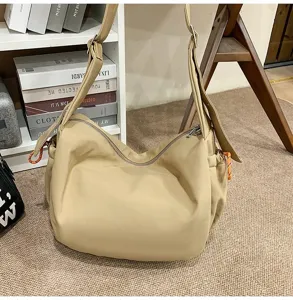 Large capacity khaki nylon dumpling hobo bag in a cozy minimalist interior setting