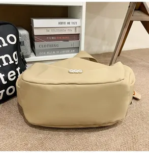 Beige minimalist crossbody dumpling bag detail view in lifestyle setting