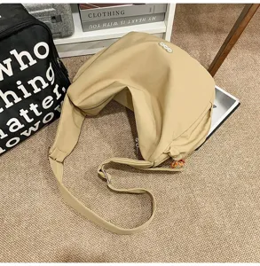 Large capacity khaki hobo bag shown in a casual lifestyle setting