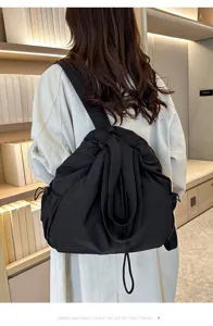 Casual nylon backpack detail showcasing large capacity, comfortable straps and stylish black finish.
