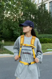 Close-up of adjustable yellow chest and waist straps on a hiking backpack