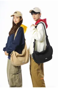 Two models showcasing large capacity crossbody dumpling bags in black and beige colors