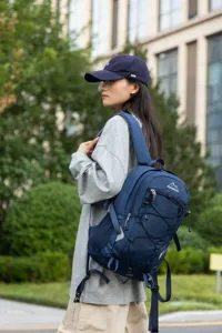 Outdoor urban lifestyle shot of a woman wearing a blue large capacity hiking backpack.