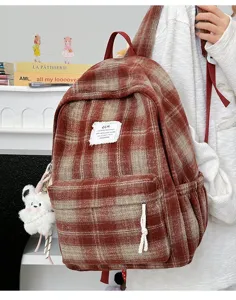 Retro plaid wool backpack detail view, casual school bookbag with front pocket and charm.
