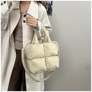 Stylish large capacity beige quilted puffer tote bag shown on a model in detail