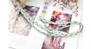 Detail view of handmade braided colorful phone lanyard strap with floral accents