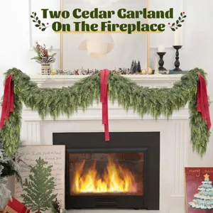 Two lush artificial cedar garlands with festive red ribbons draped over a white fireplace