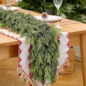 Detailed view of artificial cedar garland with soft-touch needles on a festive table.