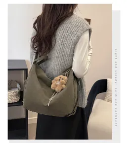 Trendy olive green large capacity hobo bag shown from the back on female model