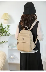 Back view showing the stylish fit and woven texture of this minimalist beige backpack