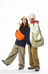 Stylish large capacity dumpling messenger bags worn by models in casual sporty style