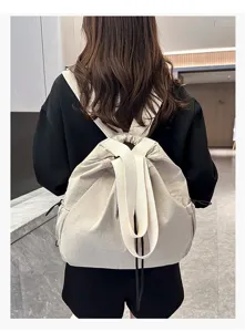 Detailed view of the casual nylon backpack showcasing its spacious design and durable straps.