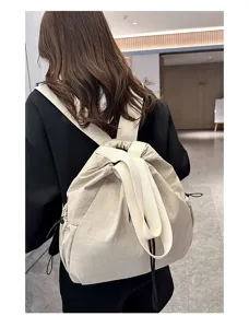 Detailed rear view of casual beige nylon drawstring backpack, perfect for daily commute.