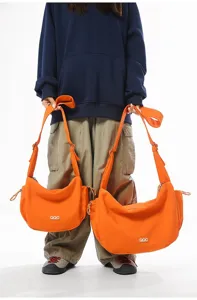 Comparison of orange dumpling crossbody bags in large and small sizes for travel