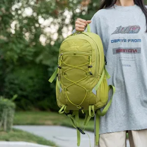 Large capacity light green outdoor hiking backpack held by model in natural setting