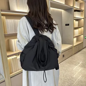 Casual large capacity nylon backpack for women, lightweight commuter school bag with straps.