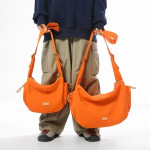 Set of stylish orange dumpling crossbody bags in small and large sizes for casual sports travel