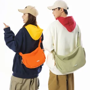 Stylish large capacity crossbody dumpling bags in orange and green for daily travel.