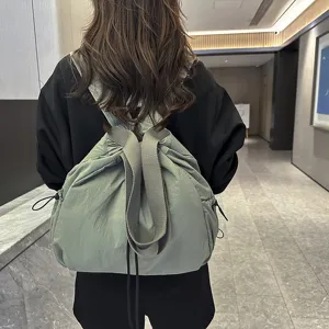 Detailed view of the casual nylon backpack showcasing its drawstring closure and comfortable straps.
