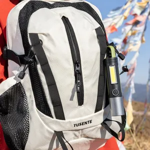 Detail view of a lightweight outdoor hiking backpack with TUSENTE logo in a scenic setting