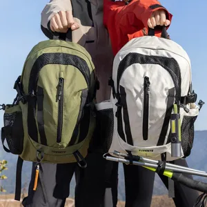 Close-up detail of outdoor hiking backpacks in olive green and off-white with mesh design.