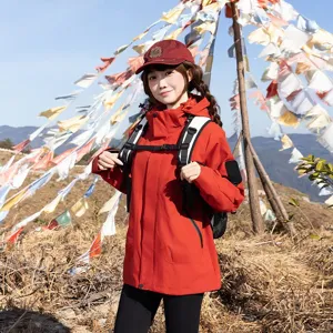 Outdoor hiking backpack worn by a woman during a mountain trek with prayer flags.
