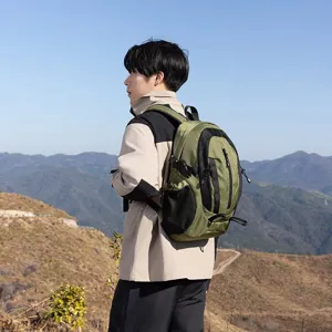 Lightweight green outdoor hiking backpack shown on a model in a scenic mountain setting