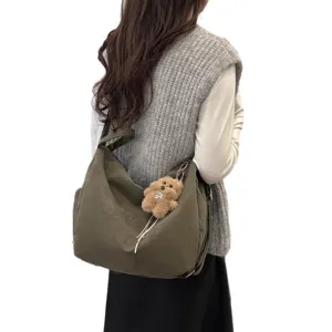Minimalist large capacity women's olive green hobo bag featuring a cute teddy bear plush charm