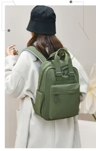 Casual nylon backpack detail featuring durable fabric, top handles, and comfortable straps.