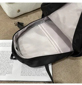 Detailed view of casual black backpack interior lining, spacious daily student school bag.
