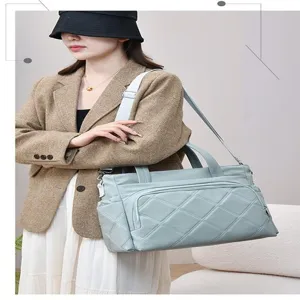 Detailed view of the large capacity quilted tote bag, stylish solid color mom bag for travel.