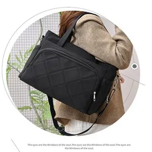 Detailed view of black quilted tote shoulder bag showcasing durable fabric and stylish stitching.
