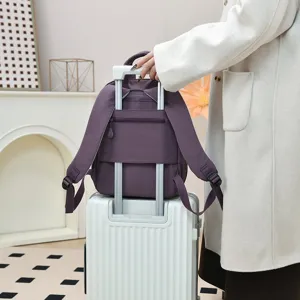 Casual women's nylon backpack, stylish purple travel school bag with luggage strap.