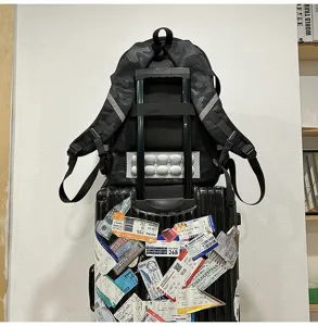 Detailed view of casual camouflage backpack with trolley strap and breathable back panel.