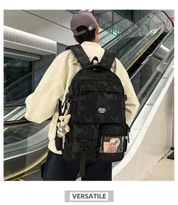 Detail view of a stylish black camo backpack with large capacity, multiple pockets and cute bear.