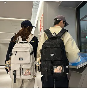 Detail view of casual fashion backpack with large capacity, transparent pocket, and cute bear charm.