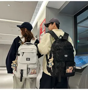 Casual large capacity student backpack with multi pockets and cute pendant for daily commute.