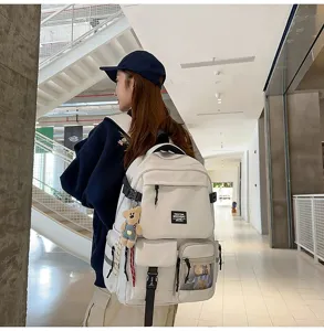 Stylish large capacity white student backpack with multi pockets and cute bear pendant.