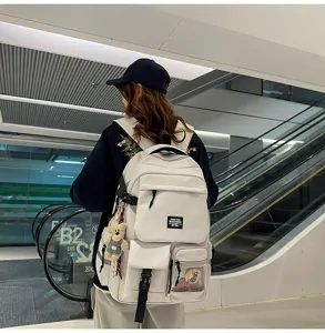 Casual white student backpack with multiple pockets, large capacity daily commute style detail.