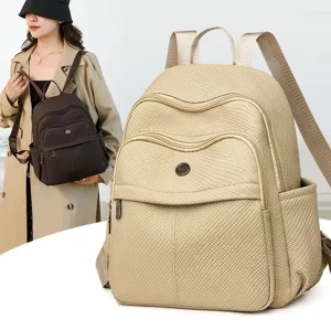 Minimalist solid color backpack with multi-compartment design for travel and daily school use